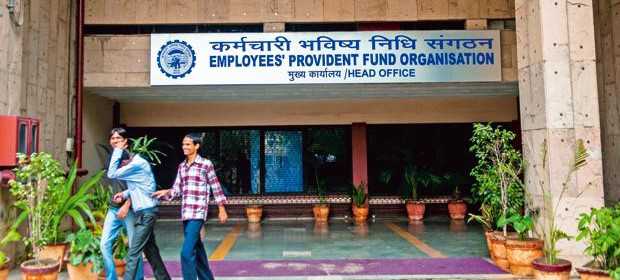 3 men in front of entry gate of employee provident fund organization